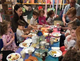 Children and their families participate in Tot Shabbot.