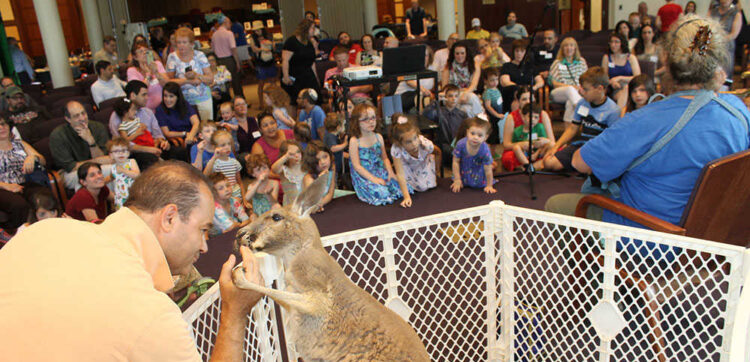 Children sing songs alongside a kangaroo at Down Under Shabbat.